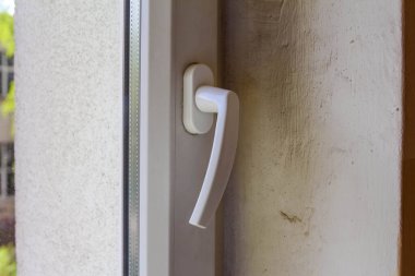 Modern Ev 'in Güvenlik Detaylarını Gösteren Açık Renkli Çerçevedeki Beyaz Pencere Kilit Mekanizması