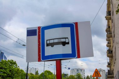 Açık Gökyüzü ile Şehir Merkezinde Mavi Arkaplan ve Beyaz Otobüs Simgesi ile Kamu Otobüs Durağı