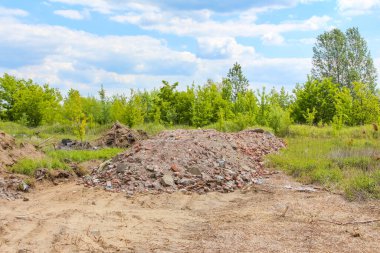 Kalkınma bölgesinde ağır makineler ve bozuk toprakla temizlenmiş inşaat alanı