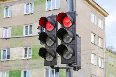 İkili trafik ışığı sistemi kentsel konut arkaplanıyla aynı anda kırmızı ve yeşil sinyalleri gösteriyor