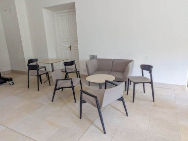 Sleek modern dining chairs with upholstered seats arranged in spacious bright interior with neutral color palette