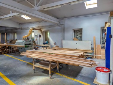 Warsaw, Poland, September 20, 2025. Spacious modern carpentry workshop with organized workbenches and equipment creating efficient professional working environment. High quality photograph