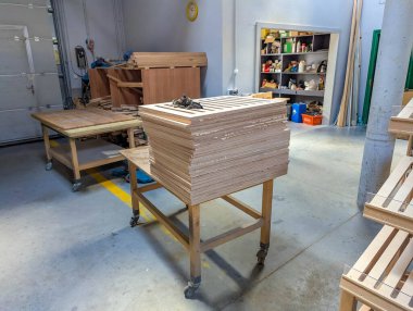 Warsaw, Poland, September 20, 2025. Carpenter working at wooden workbench with hand tools creating custom furniture in traditional workshop setting. High quality photograph