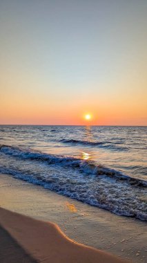 Baltık Denizi 'nde altın saat batımı dalgalar ve ıslak kumlar Leba Polonya yakınlarında turuncu ışığı yansıtıyor. Yüksek kalite fotoğraf