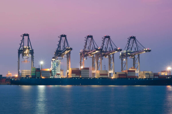 Container Cargo freight ship with working at dusk for Import Export