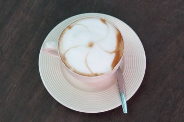 white cappuccino in a cup on the wooden background clipart