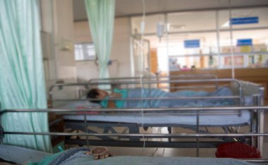 Oksijen alma yoğun bakım ünitesinde hastane yatağında yatan üst düzey adam bokeh arka plan bulanıklık