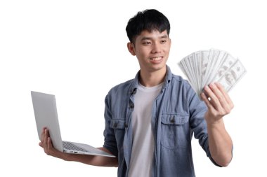 A man is holding a laptop and a stack of cash. He is smiling and he is happy clipart