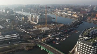 Nehir kıyısında yeni apartmanlar ve şehir inşaatı, Puslu Sabah Işığı. Szczecin Polonya.