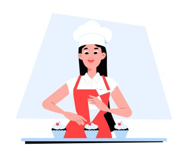 Beyaz şapkalı ve kırmızı önlüklü kadın pasta şefi, bir profesyonel veya ev fırınında kek pişirme, pasta yapma ve şekerleme sanatını sembolize ederek topkekleri süslüyor..
