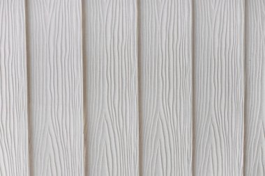 Tahta desenli, beyaz, dikey plastik tahtaların yakın çekimi, doğal ahşabın ayrıntılı taklidini vurguluyor. İnce, karmaşık tasarım çeşitli dekor ve sanatsal uygulamalar için mükemmel..