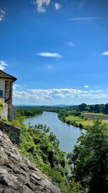 Vertical photo of the Vistula River and fields from the Benedictine Abbey wall in Tyniec, Krakow, Poland. Perfect for beautiful views, travel, and nature exploration in Bielansko-Tyniec Landscape Park clipart