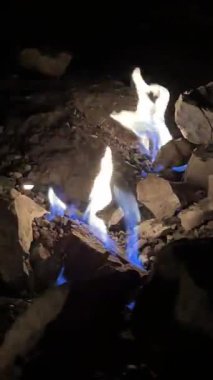 Chimaera Yanartas Dağı 'nın alevlerinin dikey videosu, Antalya, Türkiye. Dağ yamacında doğal gaz yangınları. Doğa, jeoloji, seyahat ve doğal fenomenler için ideal.