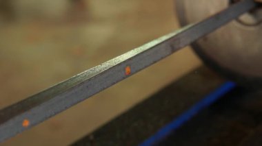 Bükülmüş metal kare çubuk. Çubuk hidrolik torsiyon makinesine yerleştiriliyor ve belli bir hızda dönüyor. Dekoratif ve işlevsel materyal, mimaride ve demircilikte rağbet görüyor.