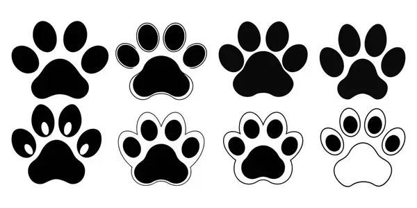 Köpek patilerinin siluetleri klip tasarımları beyaz arkaplanda basit siyah renklerdir.