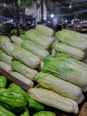 Fresh white cabbage hanging at the Flamboyan market clipart