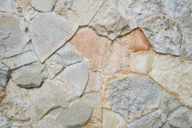 Doğal granit duvar. Kaba doğal taş. Krem rengi tuğla kaplama duvar dokusu arkaplanı.