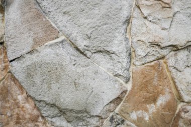 Doğal granit duvar. Kaba doğal taş. Krem rengi tuğla kaplama duvar dokusu arkaplanı.