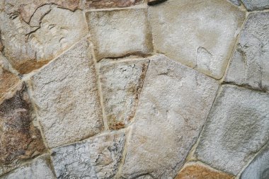 Doğal granit duvar. Kaba doğal taş. Krem rengi tuğla kaplama duvar dokusu arkaplanı.