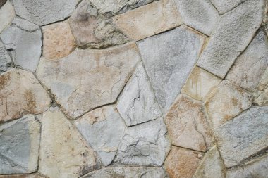 Doğal granit duvar. Kaba doğal taş. Krem rengi tuğla kaplama duvar dokusu arkaplanı.