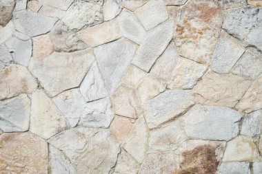 Doğal granit duvar. Kaba doğal taş. Krem rengi tuğla kaplama duvar dokusu arkaplanı.