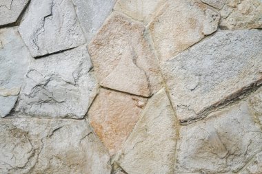 Doğal granit duvar. Kaba doğal taş. Krem rengi tuğla kaplama duvar dokusu arkaplanı.