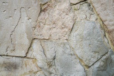 Doğal granit duvar. Kaba doğal taş. Krem rengi tuğla kaplama duvar dokusu arkaplanı.