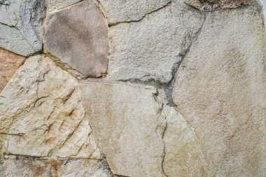 Doğal granit duvar. Kaba doğal taş. Krem rengi tuğla kaplama duvar dokusu arkaplanı.