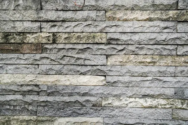 House fence wall with symmetrical patterned stone piles for background and various design purposes