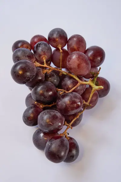 Fresh Grapes on a white background. This photo is ideal for use in poster designs, greeting cards, or as an illustration for articles about fruits.