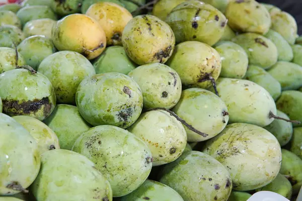 Whole fresh mangoes sold in fruit shops are suitable for design purposes, as illustrations for articles about fruits and others.