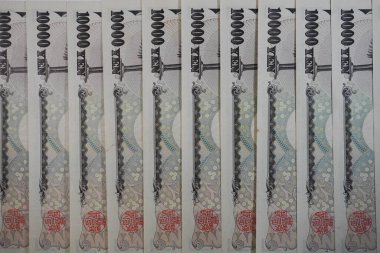 Japon 10,000 Yen banknotunun çeşitli açılardan çekilmiş yakın plan fotoğrafları. Grafik tasarımı, illüstrasyon ya da çarpıcı bir görsel öğe ve daha fazlasını gerektiren projeler için mükemmel..