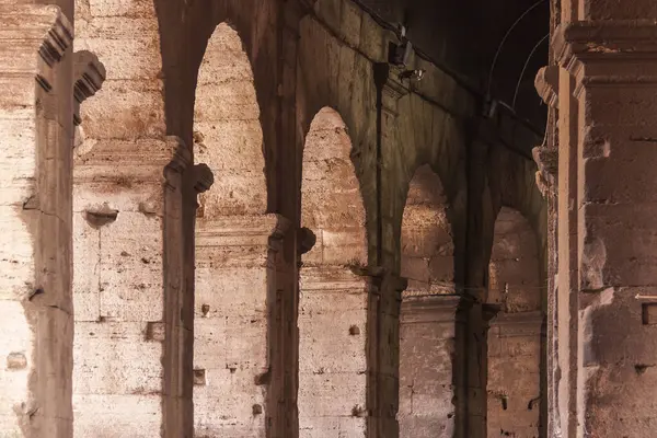 Taş kemer ve sütunları olan ve zamanın geçtiğine dair bariz işaretleri olan bir Roma inşaatının yan görüntüsü