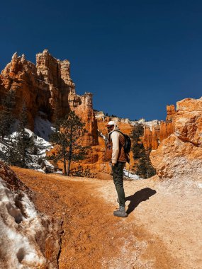 Bryce Canyon, Hiker male in Bryce Canyon, man with Canyon in Background, Nature, Landscape, Mountains, Amazing View, Tourism in Utah, USA, Hiking, Red Rocks, Hike, Sunny Day, hiking tourism clipart