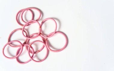Beyaz zemin üzerinde pembe lastik bantlar yığını