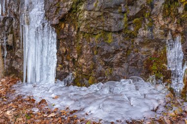 Lula Lake Land Trust, Lookout Mountain, Georgia. A close up of the ice formations beneath the cliffs of the Lula Falls Trail in winter. clipart