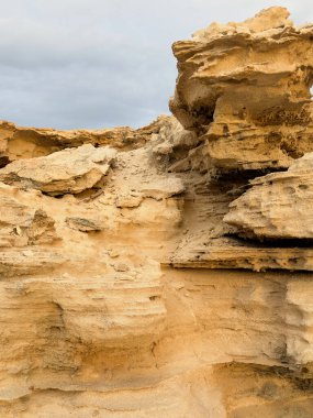 Eroded Sandstone Cliff by the Coastline Shaped by Water and Wind clipart