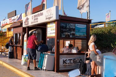 Heraklion, Girit, Yunanistan - 18 Temmuz 2024: Heraklion havaalanı Intercity otobüs servis ahşap istasyonu. Girit 'e gelen turistler nakliye için bekliyorlar