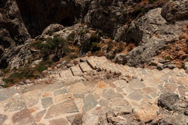 Stone stairs leading to Kourtaliotiko Gorge waterfall hike clipart