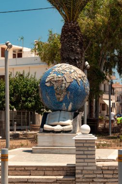 Rethymno, Crete, Greece- July 18, 2024: Globe statue monument view at Rethimno boardwalk clipart