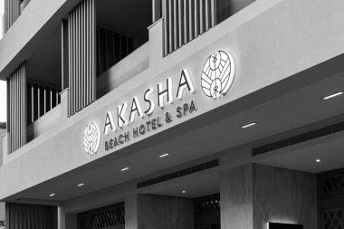 Hersonissos, Crete, Greece - July 18, 2024- Akashi beach hotel and spa front sign entrance to 5 star luxury hotel resort with sea view in black and white clipart