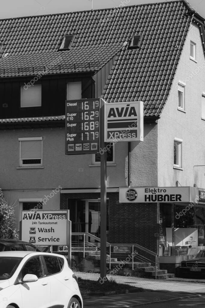 Stuttgart, Germany- March 28, 2025: AVIA International, a Switzerland independent petroleum importers distributed in Europe. Petrol station pricing advertising sign in Stuttgart. Black and white image