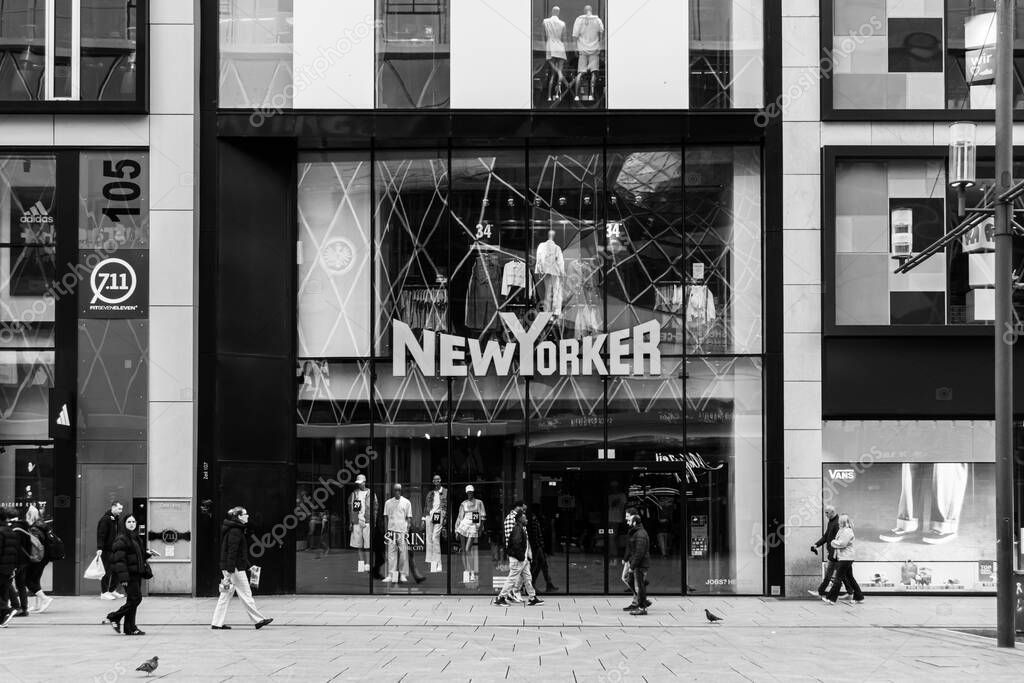 Frankfurt, Germany - April 18, 2025: Closed New Yorker fashion store across from MyZeil shopping mall in Frankfurt city center, with pedestrians passing by on street in black and white