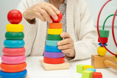 Asyalı yaşlı bir kadın, geliştirme oyunu oynuyor..