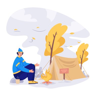 Genç adam sonbahar ormanında oturuyor.