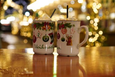 Mug of hot chocolate with marshmallows at a Christmas market. Festive drink portrait in winter. clipart