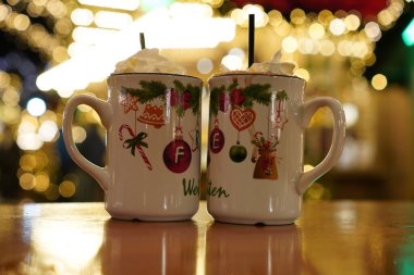 Mug of hot chocolate with marshmallows at a Christmas market. Festive drink portrait in winter. clipart