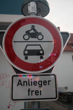 Kırmızı daireli bir tabela ve içinde motosiklet ve araba olan beyaz bir daire. Almancada 