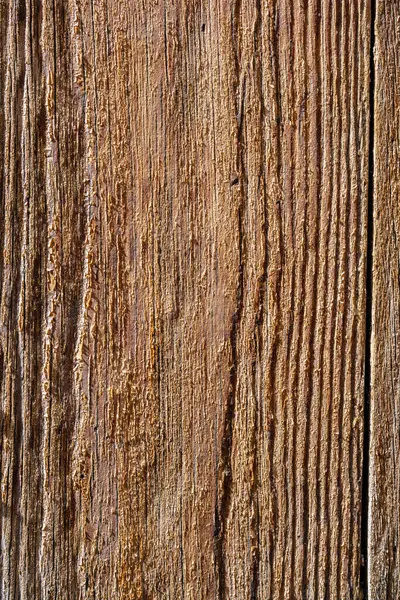 Tahta bir yüzey ve kumlu bir doku. Ahşap yaşlanmış ve kırsal bir hissi var.