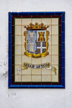 Picture Showing a mosaic sign of the town vega de san mateo clipart